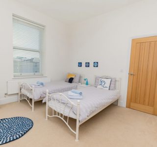 Twin room at Beach View two single beds with bed side tables and wardrobe/drawer space
